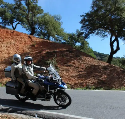 Motorrijders door kurkeikenbossen richting de kust in Andalusië